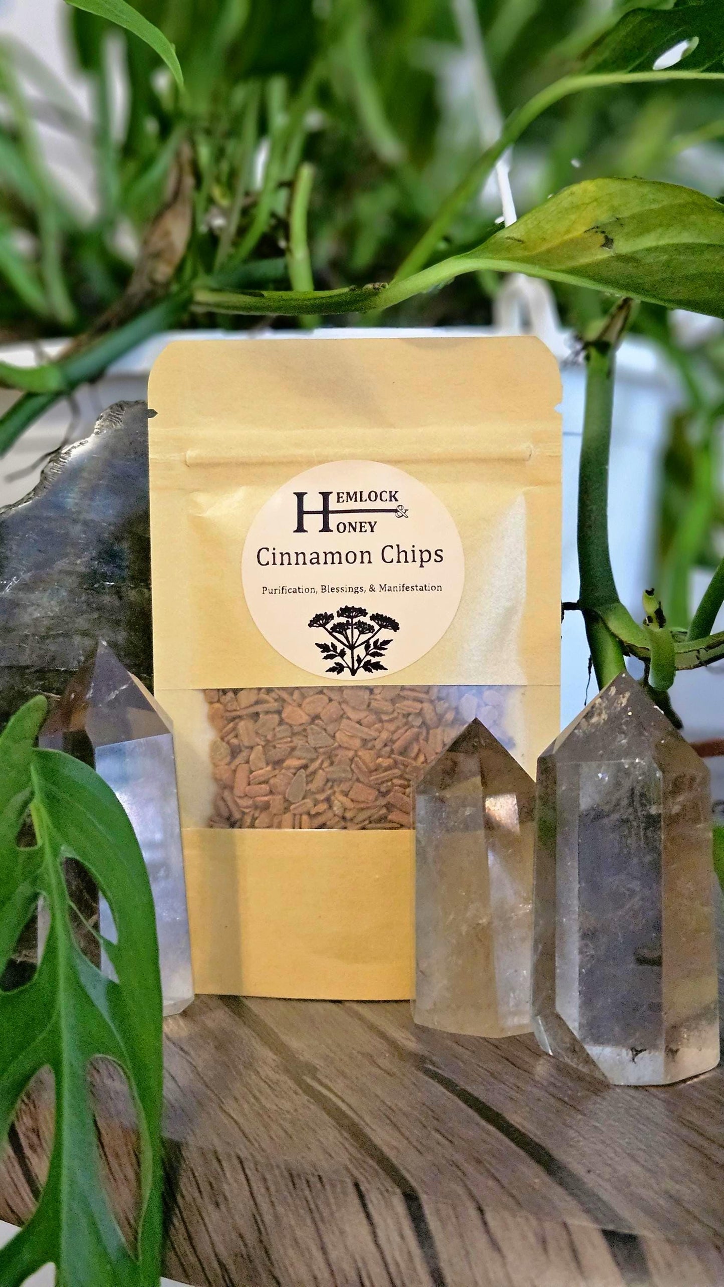 Bag of cinnamon chips placed on a table in front of crystals.