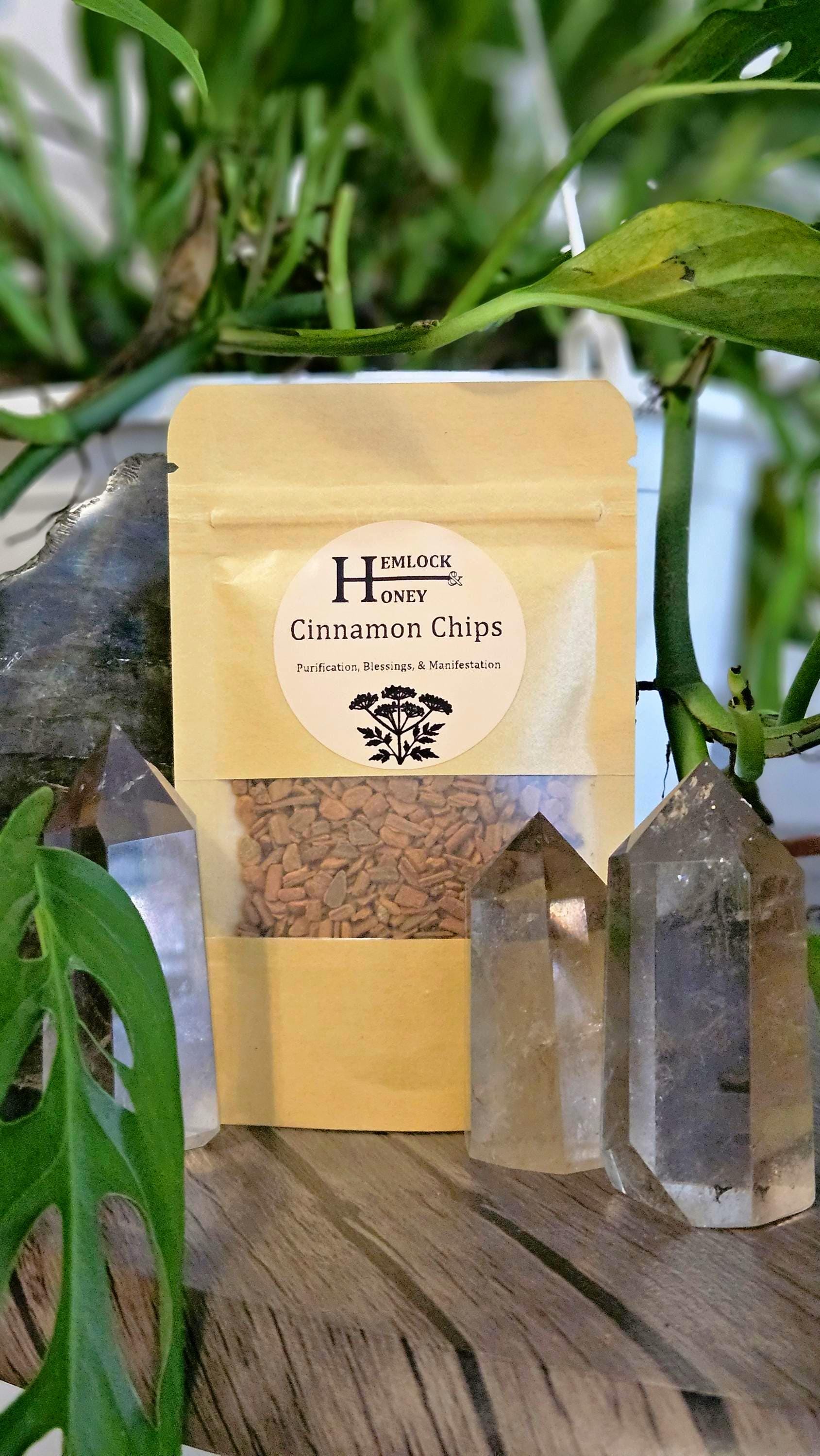 Bag of cinnamon chips placed on a table in front of crystals.